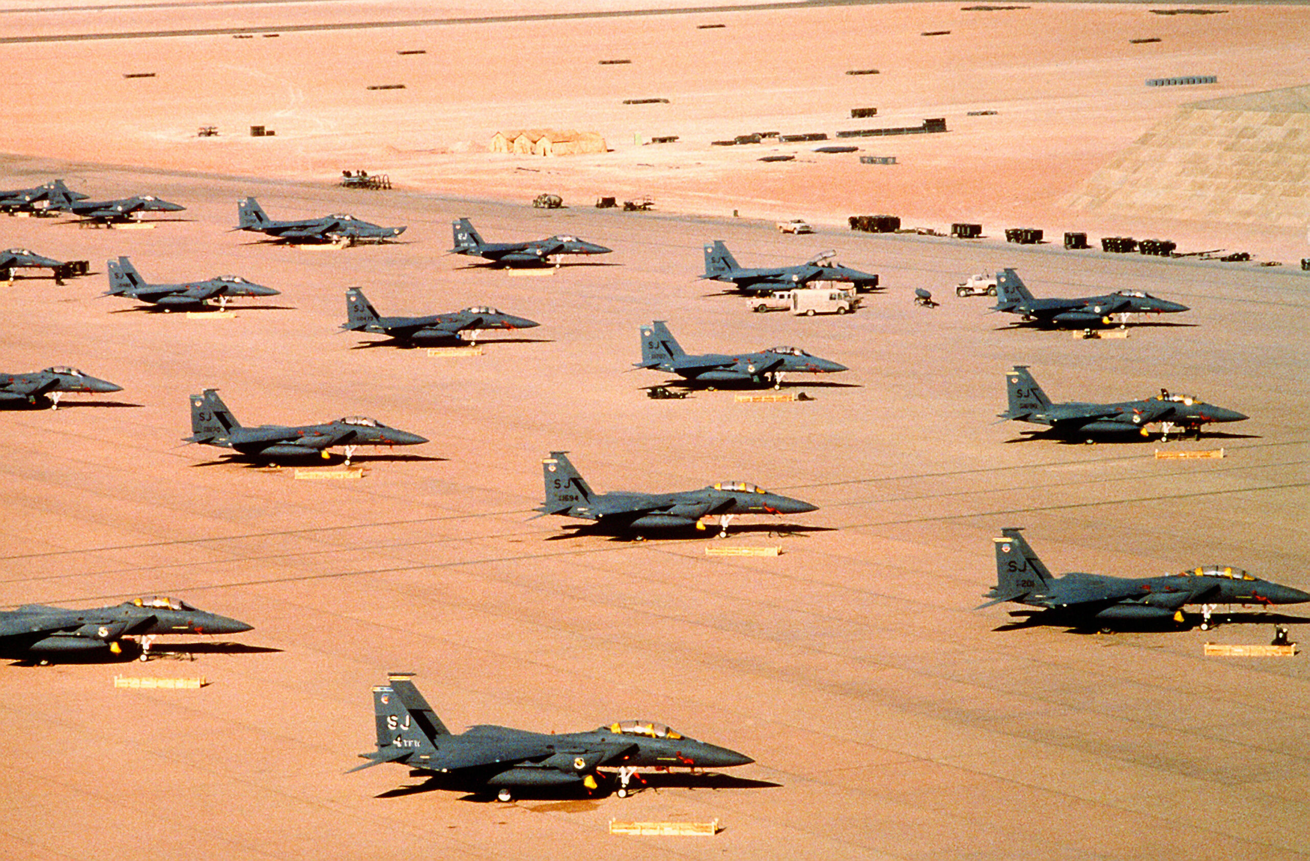 Multiple F 15E parked during Operation Desert Shield scaled